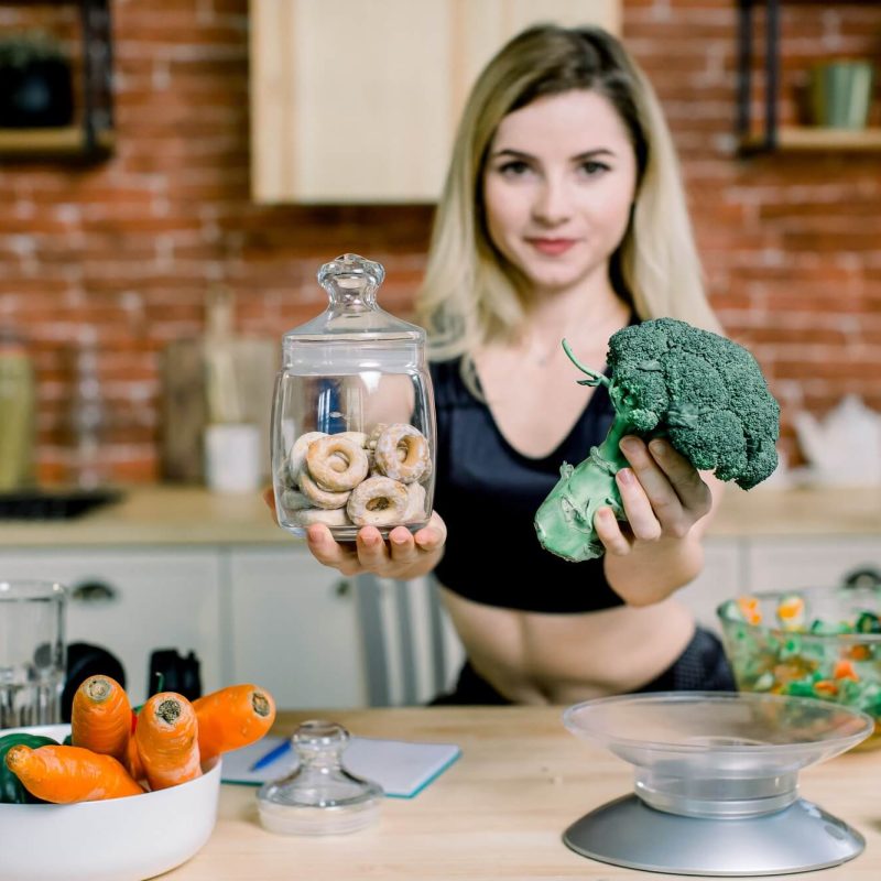 young-woman-in-black-sport-clothes-choosing-between-broccoli-or-junk-food-bagels-healthy-clean-1.jpg young-woman-in-black-sport-clothes-choosing-between-broccoli-or-junk-food-bagels-healthy-clean-1.jpg